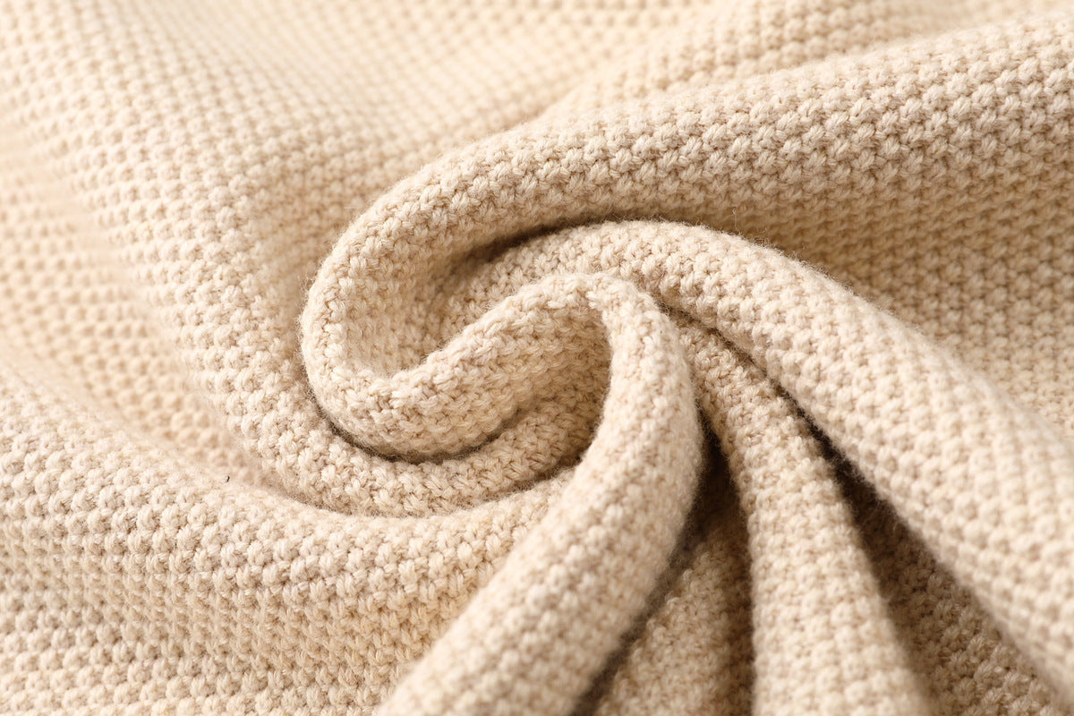 Close-up of beige textured fabric with a swirl pattern