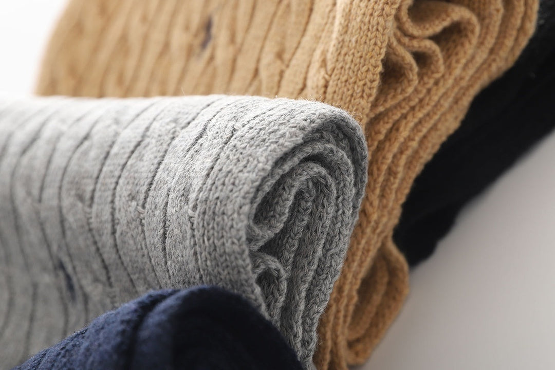 Close up of stocks of cardigan on white background