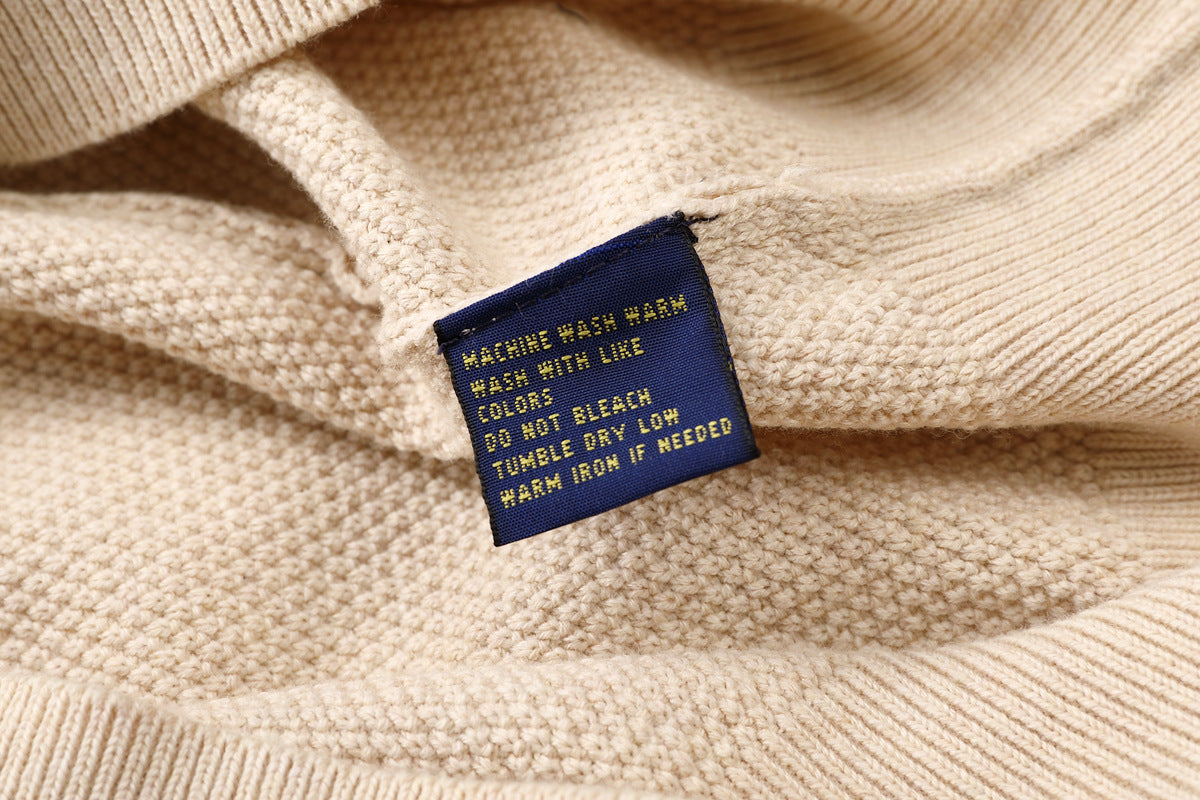 Close up of Brown cardigan with instruction badge