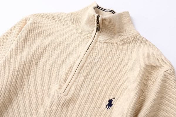 Close up of Brown Zip cardigan with a black logo on a white background
