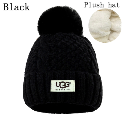 Black knit beanie with pom-pom and UGG label on a white background