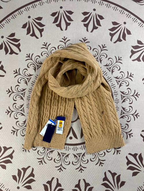 Camel - scarf with tags on a decorative patterned background