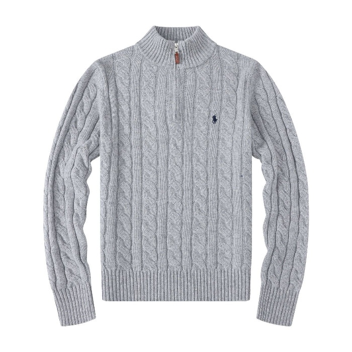 Grey blue cable knit sweater with a black logo on a white background
