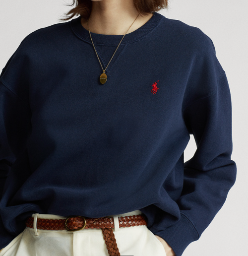 Navy cardigan with a Red logo - women wearing with white pent on a white background