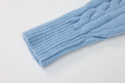 Close-up of a blue knitted item on a light gray background
