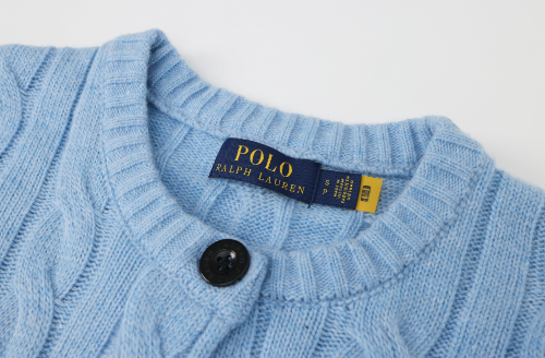 Close-up of a blue sweater with a Polo Ralph Lauren label.