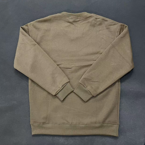 Folded beige sweatshirt on a dark gray background