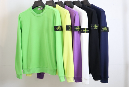 Five sweatshirts in green, yellow, purple, black, and white on hangers with a visible brand logo.