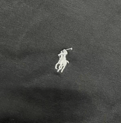White embroidered logo on a dark fabric background
